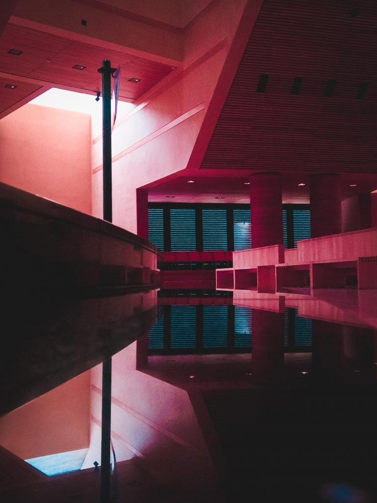 A mysterious and abstract view of a window in a church, the colours are altered to make the church's wood appear pink