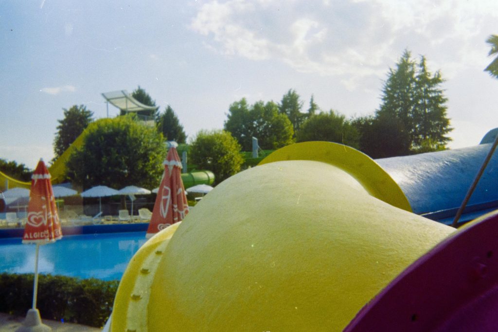 a waterslide with a desert pool in the background
