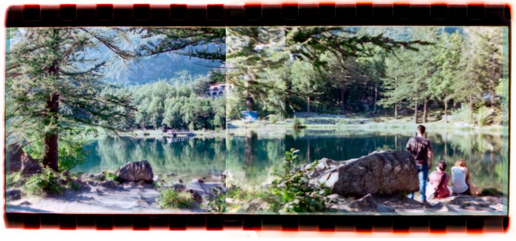 2 photos slightly overlapping on a roll of film, creating an impossible mountain lake landscape shot